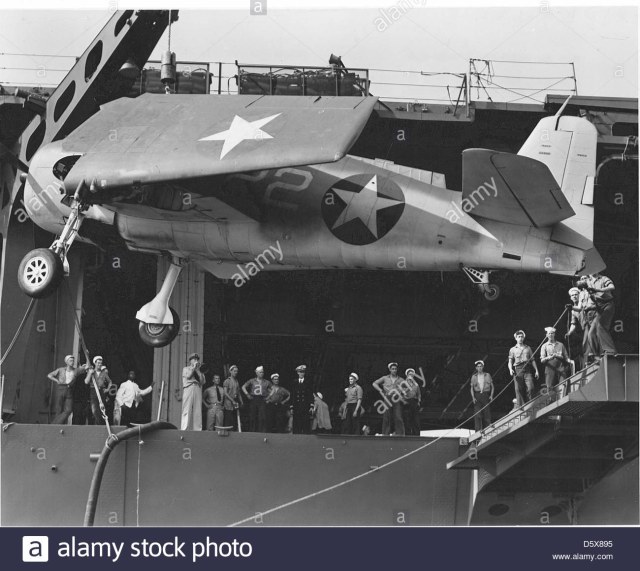 grumman-f6f-3-hellcat-of-fighting-squadron-vf-1-is-hoisted-onto-the-D5X895.jpg