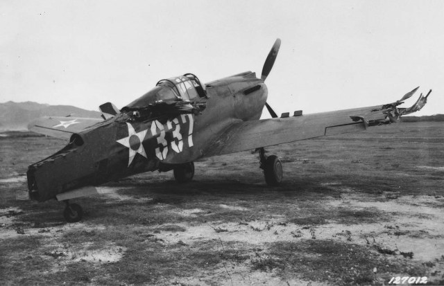 neg_0066_damaged_P-40_after_Japanese_attack_BellowsField_1941.jpg