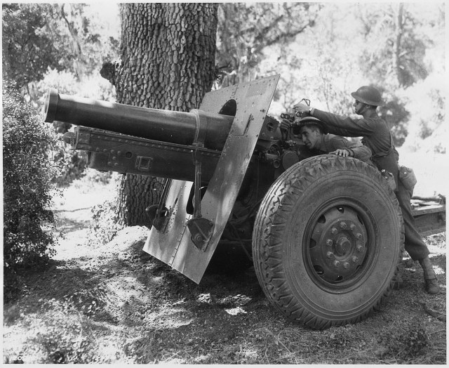 Sgt._James_B._Aets_uses_a_quadrant_to_determine_the_elevation_of_the_155mm._Hawitzer,_while_Cpl._Charles_J._Hines..._-_NARA_-_196472.jpg