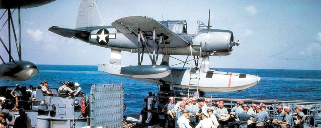 A catapult-mounted Vought OS2U-3 Kingfisher is poised above crewmen of the battleship USS Missouri in 1944.jpg
